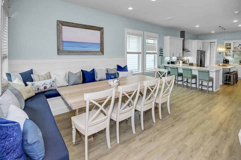 The dining area features large built-in bench seating, and a  farm house table with seating for up to 10 people! Additional 7 seating at th