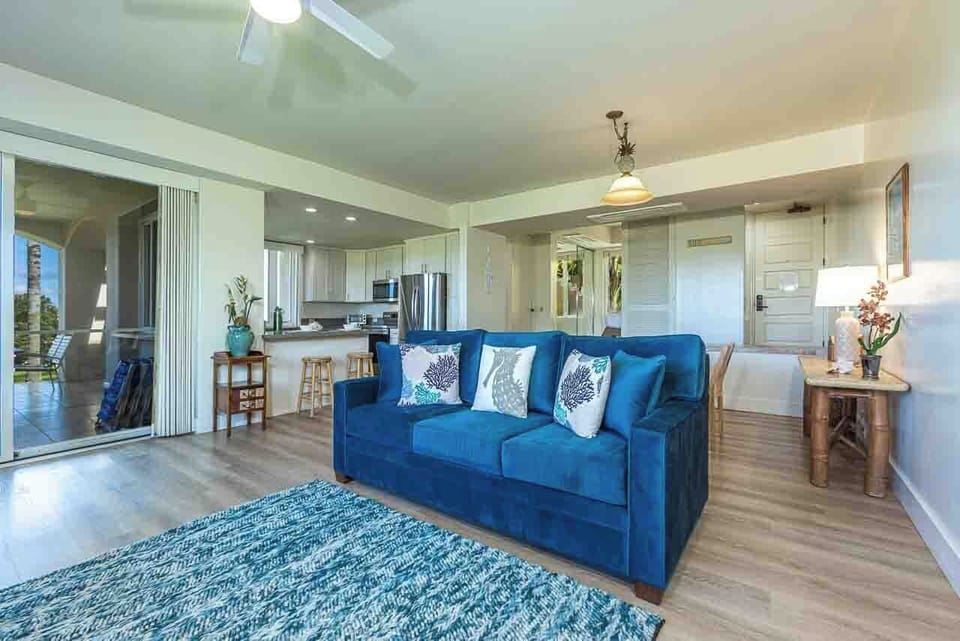 Sink into the plush blue sofa and feel instantly at home in this bright, open-plan space where coastal calm meets modern comfort.