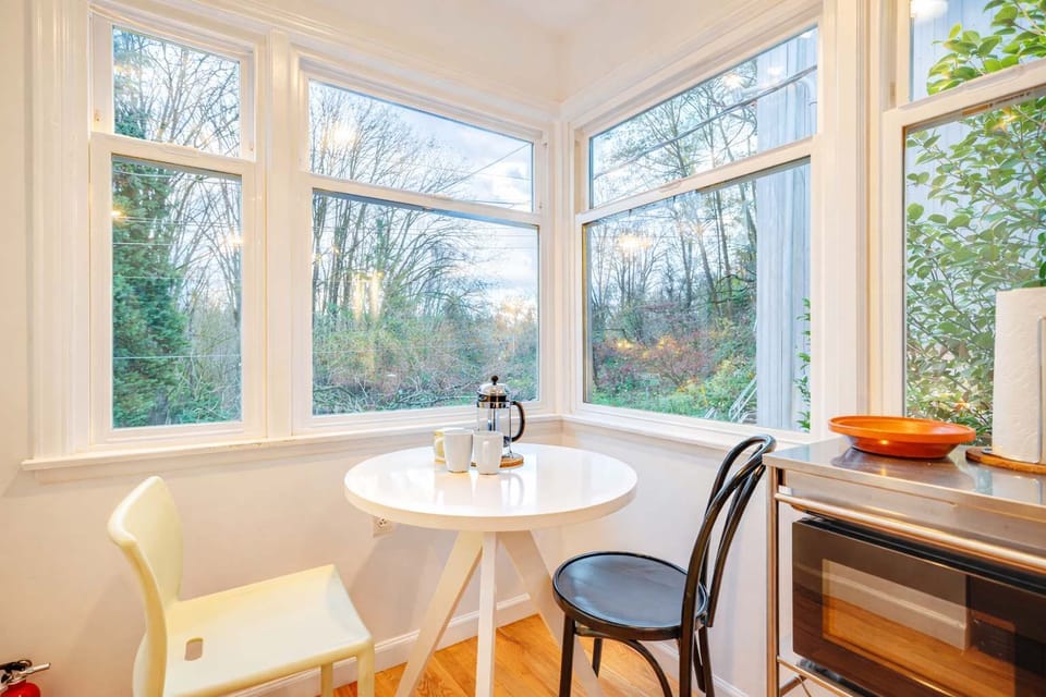 Sun-filled breakfast nook with charming seating and lovely outdoor views to start your day right.