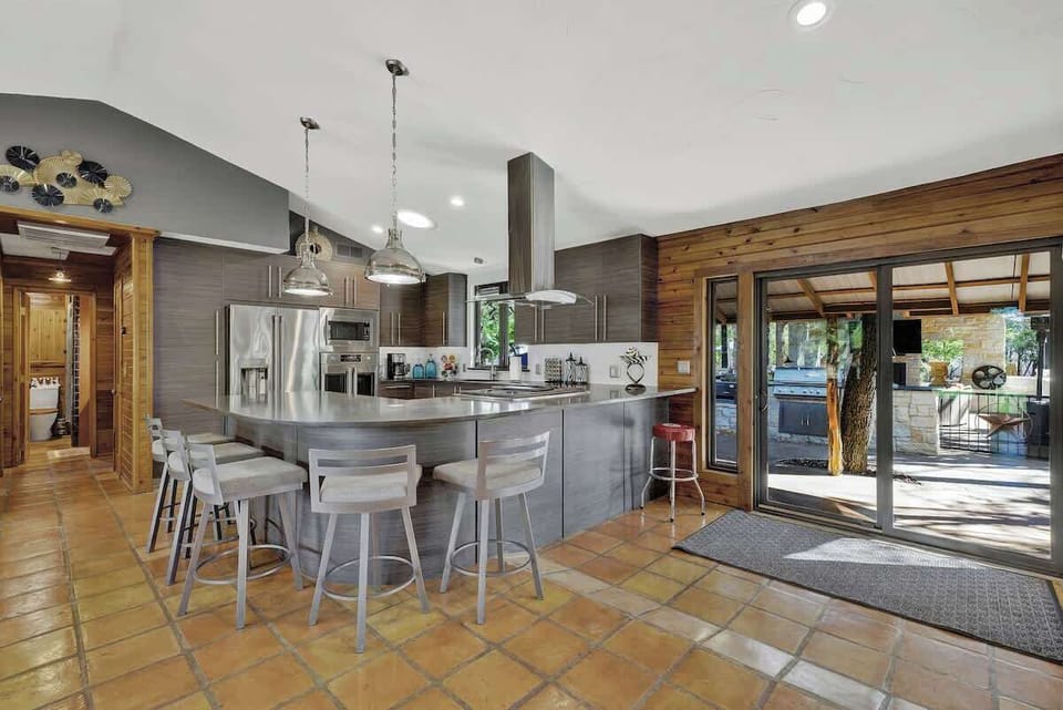Wrap-around bar seating allows families to spend time preparing a delicious meal in the fully equipped kitchen.