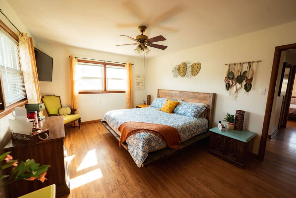 Wake up to natural light and lai-d back retro vibes- this master bedroom with King Bed blends comfort with a hint of charm.