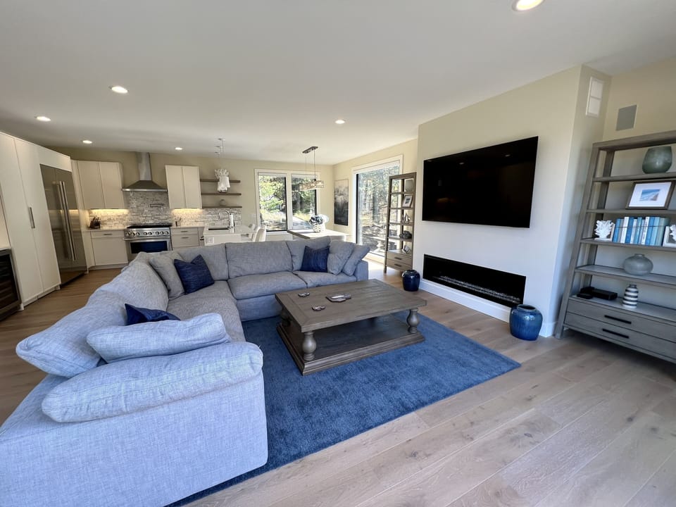 Living area w/ Restoration Hardware sectional, flat-screen TV & gas fireplace