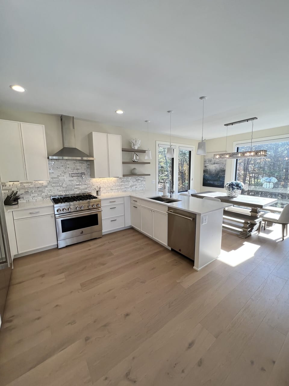 Gourmet kitchen with Jen Air appliances, quartz counters, and marble backsplash