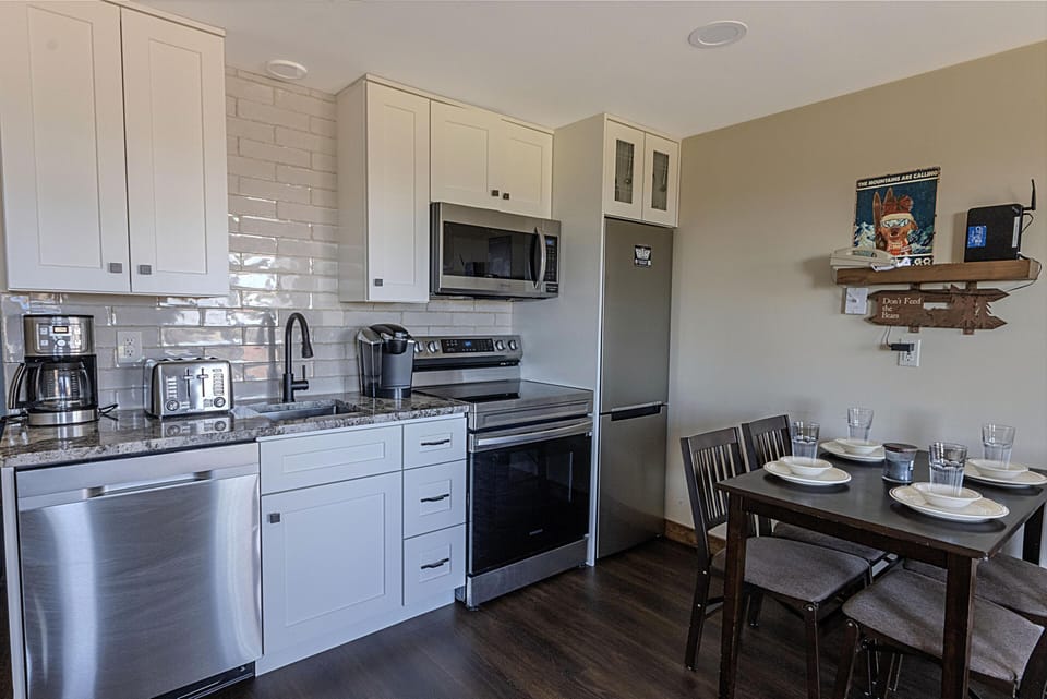 The high-end kitchen has gorgeous granite countertops, stainless steel appliances, and updated cabinets.