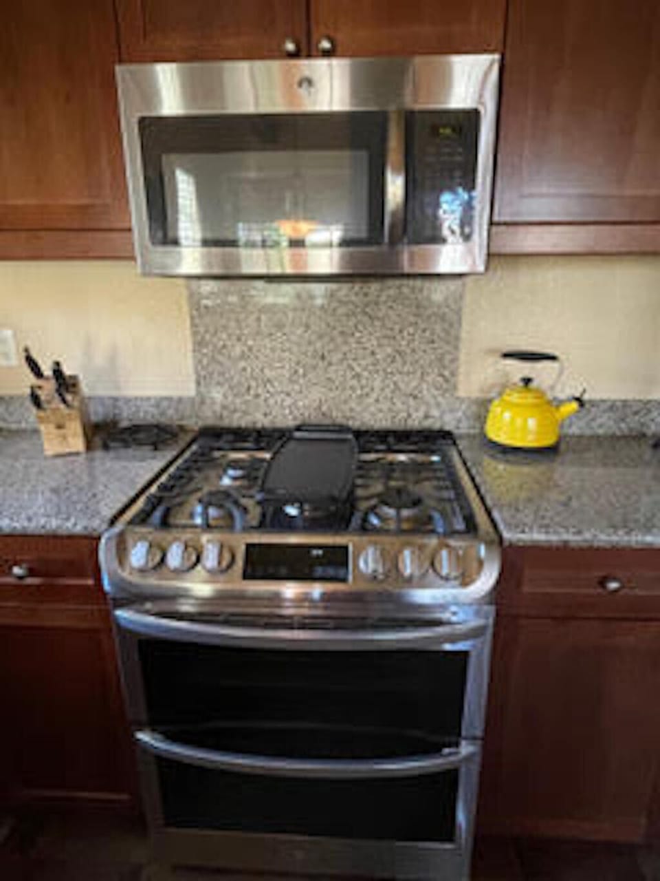 Stainless steel LG 5-burner gas range and microwave.
