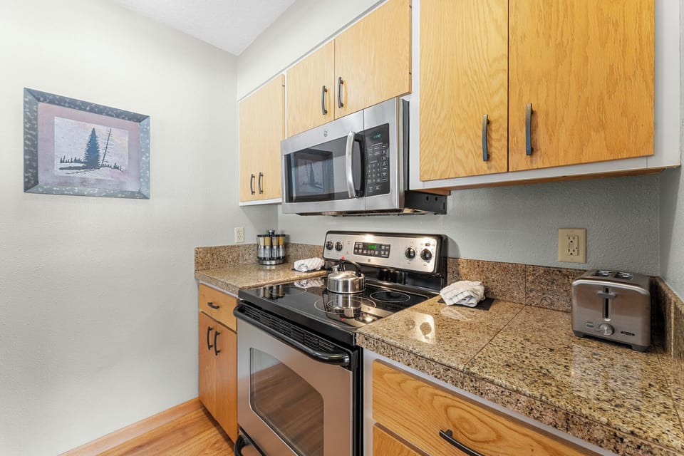 Your fully equipped kitchen awaits with granite countertops, stainless appliances, and everything needed to create memorable meals together.