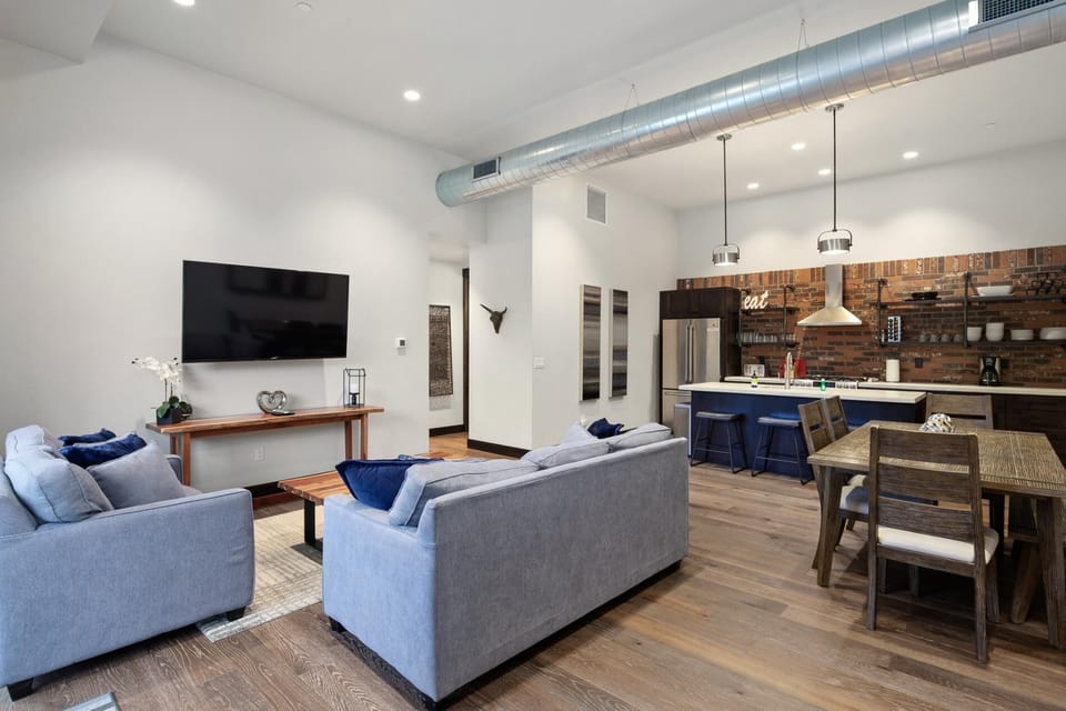 The grand room features an open concpet living, dining, and kitchen area.