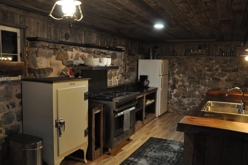 Old refrigerator turned into pantry. Commercial gas stove. 