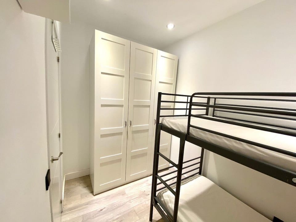 View of one of the bedrooms with a bunk bed and wardrobe 