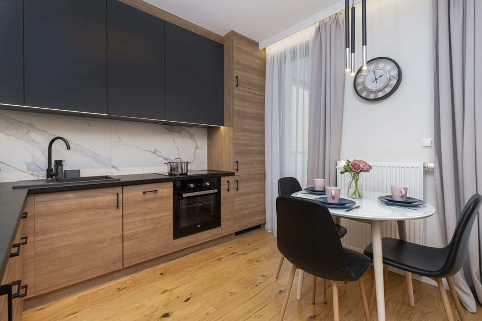 A stylish kitchen and dining area with wooden cabinetry and a contemporary design.
