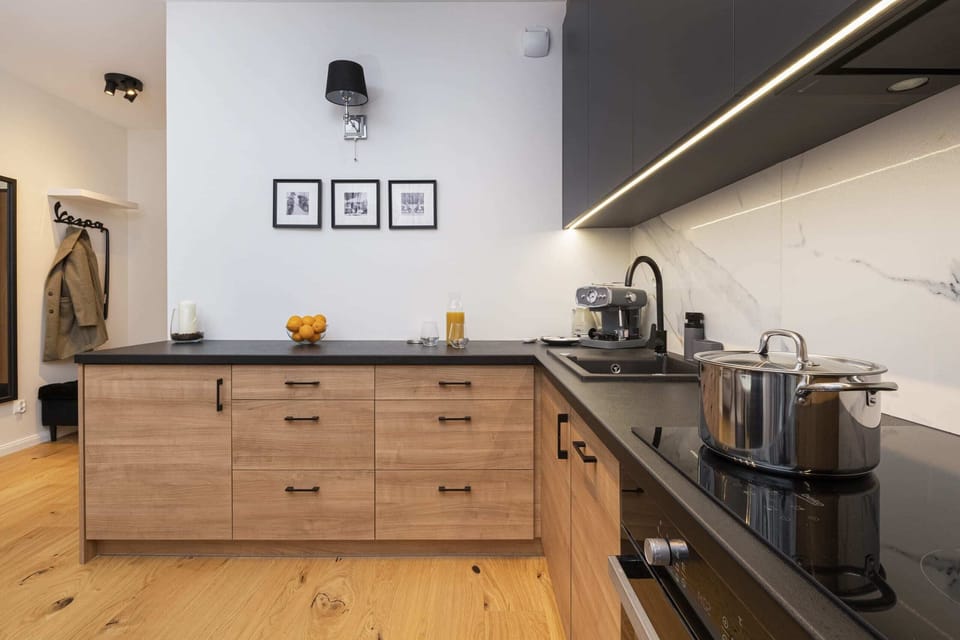 A wide-angle view of the kitchen, showcasing the sleek layout and modern appliances.
