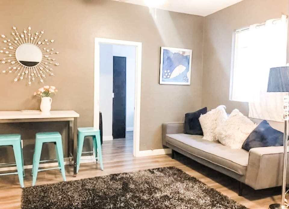 The living room area  includes (1) sofa bed and (1) futon as well as a ROKU Smart TV