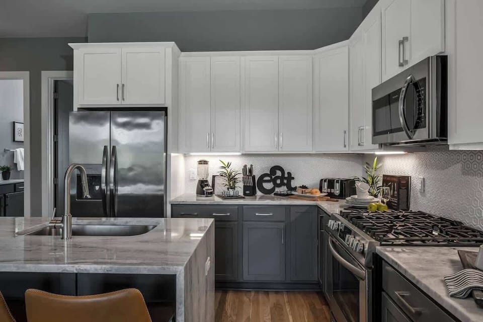Chef-ready kitchen with stainless steel appliances and complete cookware set.
