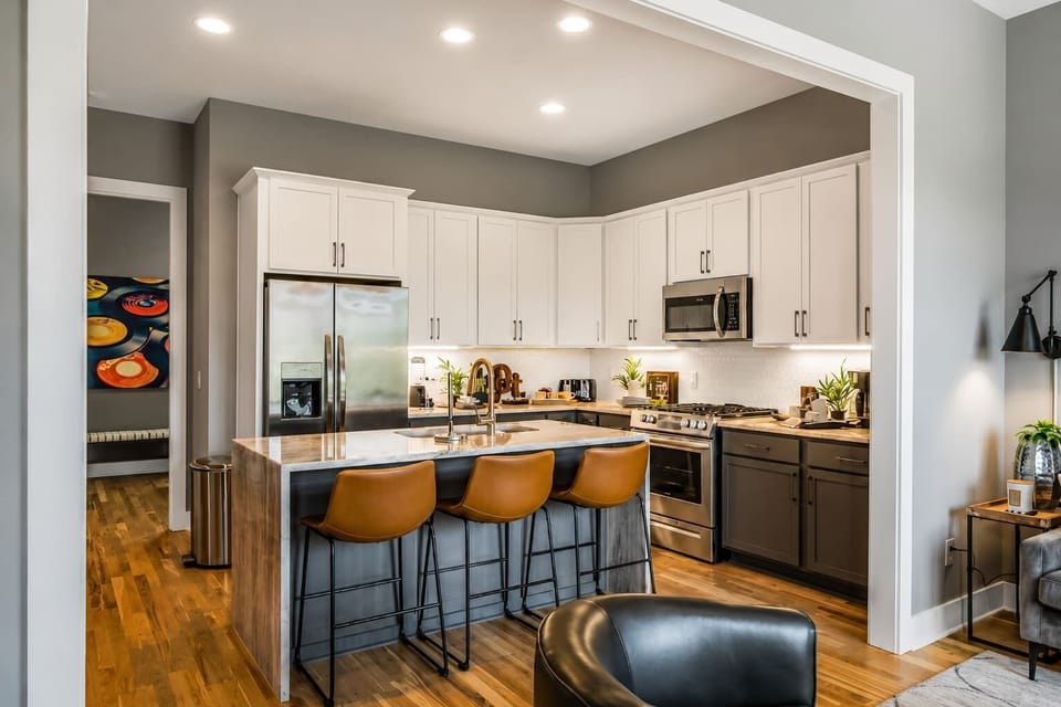 Modern kitchen with island seating for three, perfectly connected to the living space for gatherings.