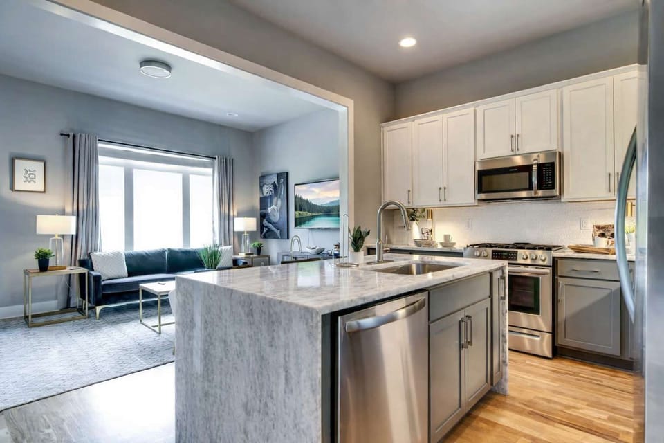 Level 2 features a fully equipped kitchen with an island, sink, and dishwasher.