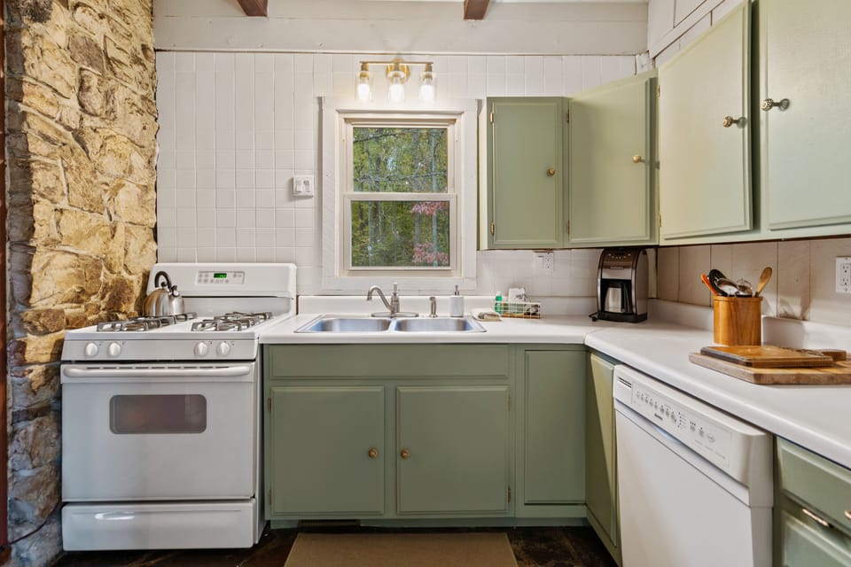 A well-equipped kitchen boasts a dishwasher, gas range, and full-sized fridge.