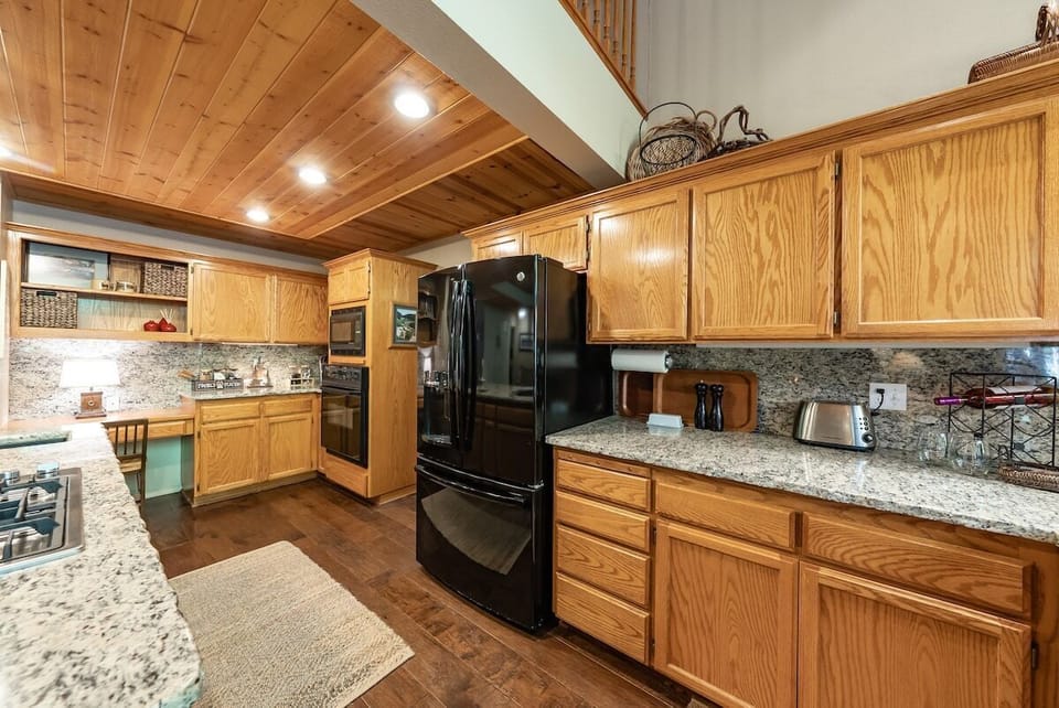 The kitchen is open to the dining area. It is a great space to visit while preparing meals.
