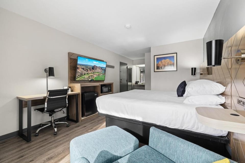 Settle in with plush bedding, big TV, and work desk.