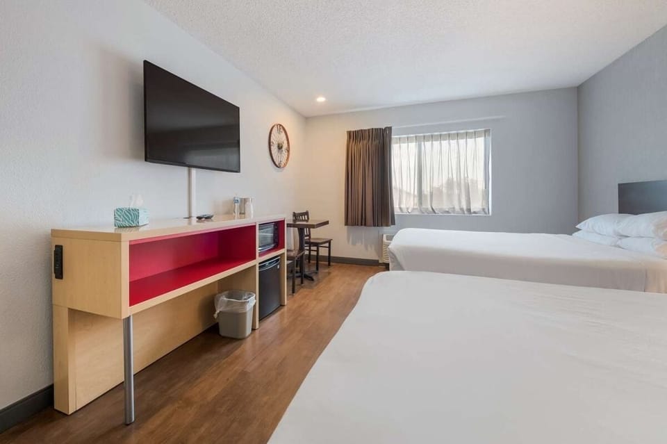 Stretch out together in a bright room with work desk.
