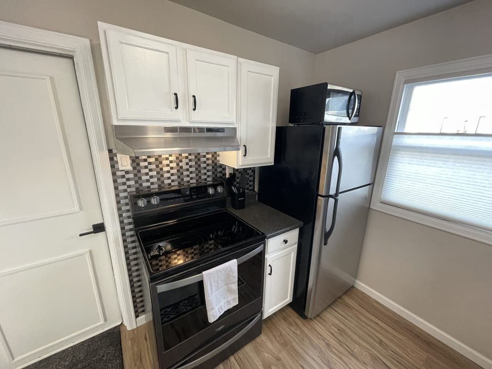 Well stocked Kitchen with stainless steel appliances. Dishwasher and glass stove