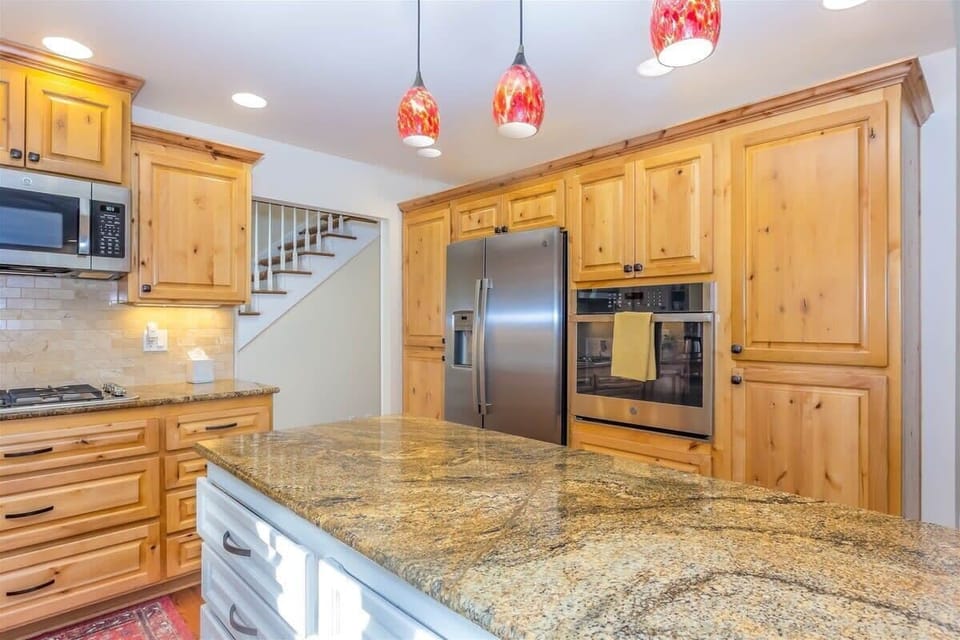 The hallway open to the right to an open concept kitchen which leads directly to the dining area and sunroom