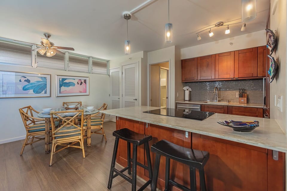 Modern kitchen flows seamlessly into the dining area, perfect for cooking together and sharing meals.
