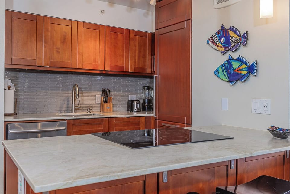 Your sleek kitchen features modern appliances and induction cook top
