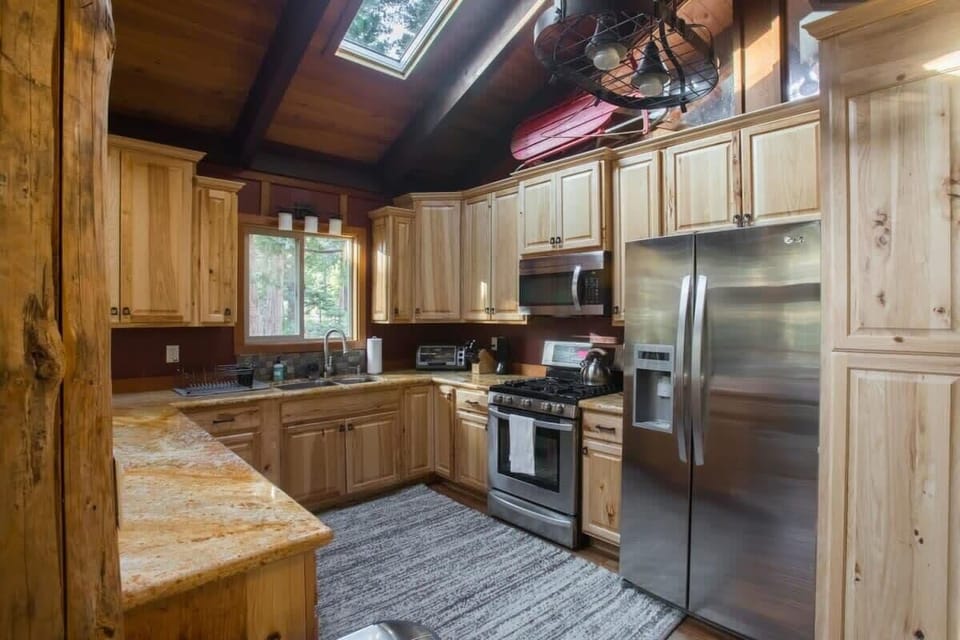 The fully equipped kitchen includes skylights, granite countertops, and stainless steel appliances plus all of the kitchenware you’ll need for home-cooked meals.