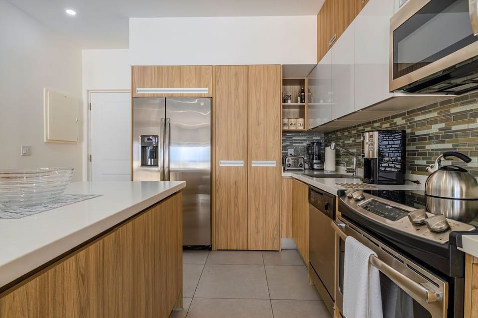 Step into your private bathroom, where clean lines meet modern comfort. A sleek glass-enclosed shower, crisp white fixtures, and thoughtfully placed toiletries await your arrival, making every refresh feel effortless and rejuvenating.
