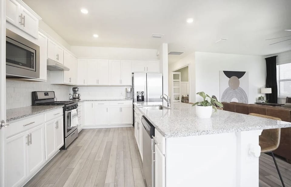 Granite counters with Marble backsplash and stainless steel appliances 