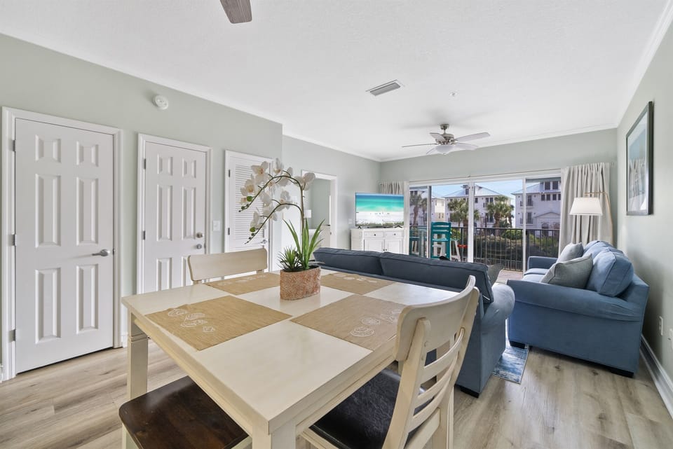Relax in your spacious living area with calming coastal views, comfortable seating, and a dining table perfect for morning coffee or evening meals together.