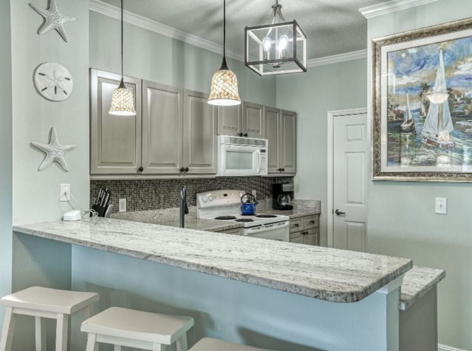 Prepare coastal-inspired meals in your fully equipped kitchen with granite counters, perfect for gathering around the breakfast bar.