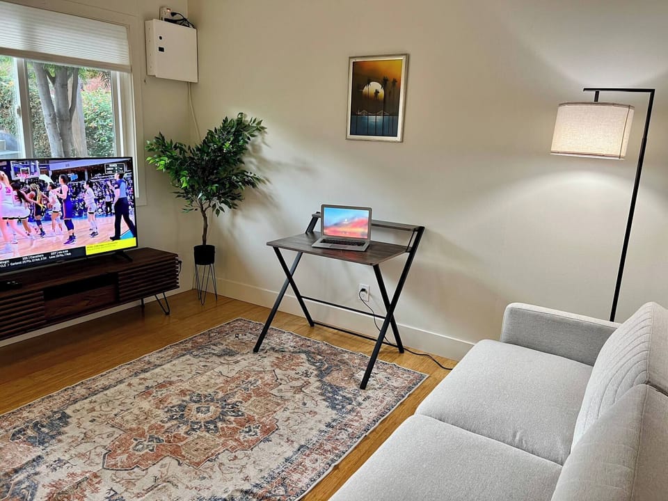 Living room with easy foldable desk, and convertible sofa bed.
