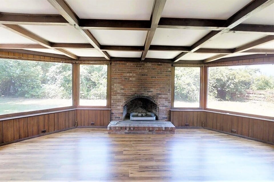Sunroom which contains a couch and can fit 2 or 3 air mattresses. 