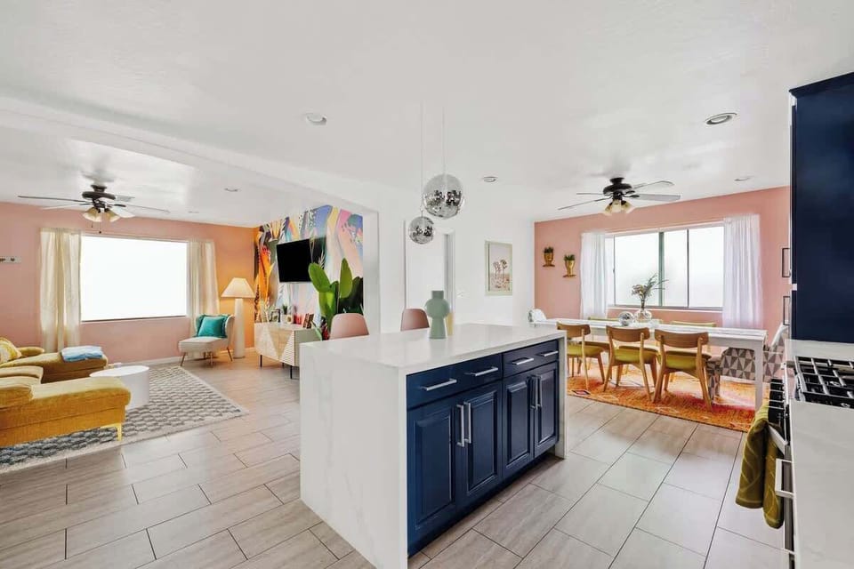 Bright kitchen & living flow w/ colorful touches that make gatherings feel effortless.