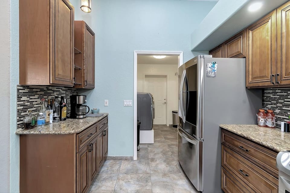 Kitchen with Stainless Refrigerator and Laundry Room Past Kitchen 
