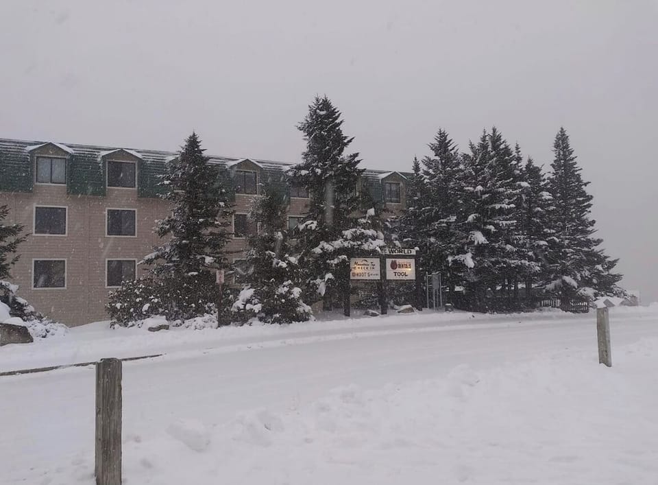 Snow covered Top of the World. Shuttle Stop in front of the building. 