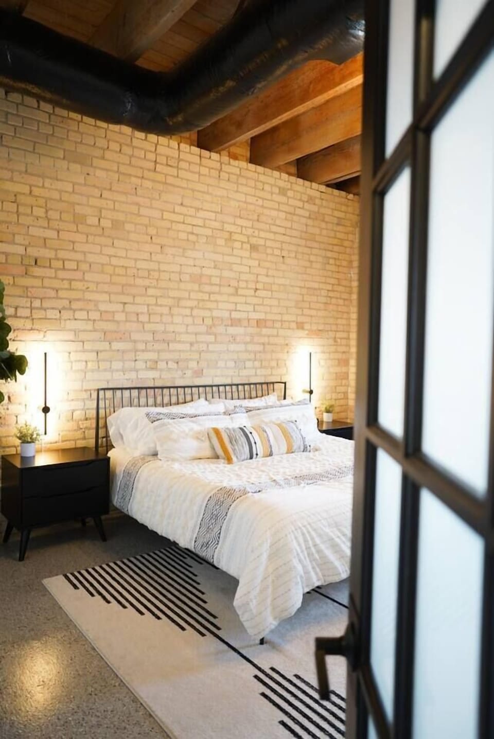 Walk through french doors and into our signature king room, which boasts an 11' brick wall with masonry that dates back to the late 1800s. You'll also enjoy views of Lake Superior and Lake Avenue. There is also a Roku TV where you can log into all of your
