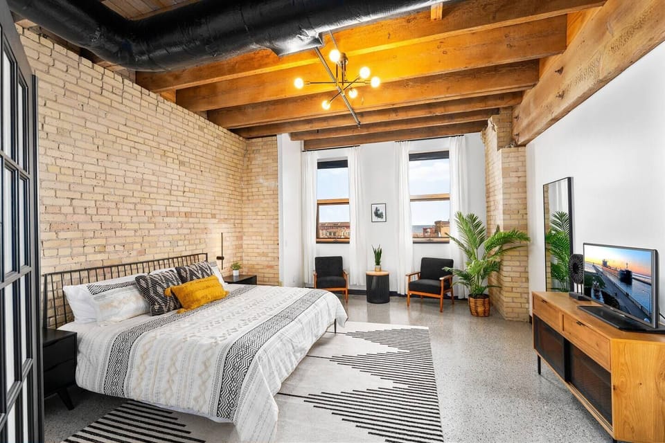 Walk through french doors and into our signature king room, which boasts an 11' brick wall with masonry that dates back to the late 1800s. You'll also enjoy views of Lake Superior and Lake Avenue. There is also a Roku TV where you can log into all of your