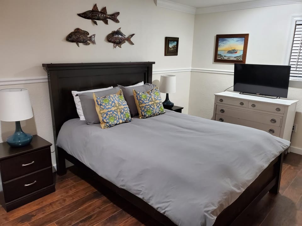 Master bedroom with queen sized bed and large walk in closet. 