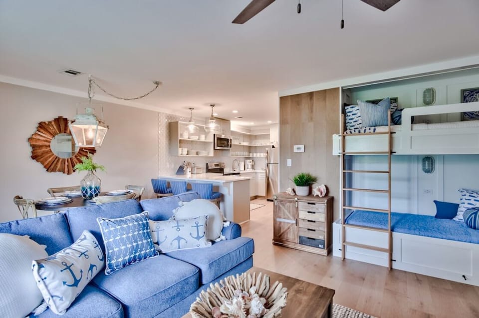 Spacious living area with queen sleeper sofa and custom twin bunks. Sleeps 6.