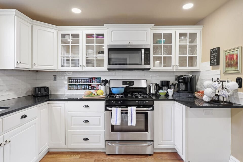 Kitchen stocked with coffee, spices, oils and cookware