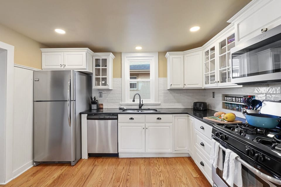 Kitchen with gas stove, new appliances and kitchen pantry items