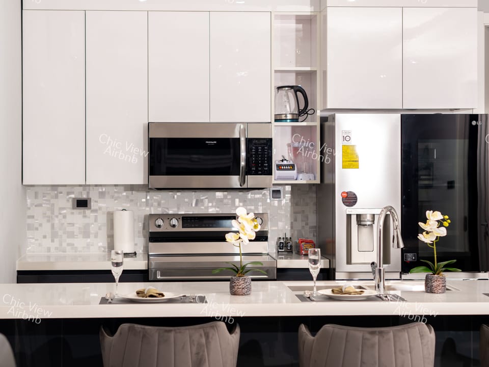 The kitchen fully equipped with Microwave, Smart Refridgerator, Blender, etc.