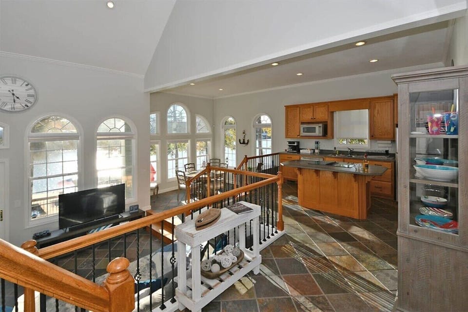 Foyer overlooks the open floor plan of the kitchen, dining, and living spaces