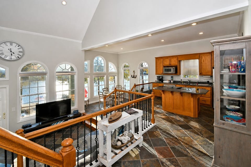 Foyer overlooks the open floor plan of the kitchen, dining, and living spaces
