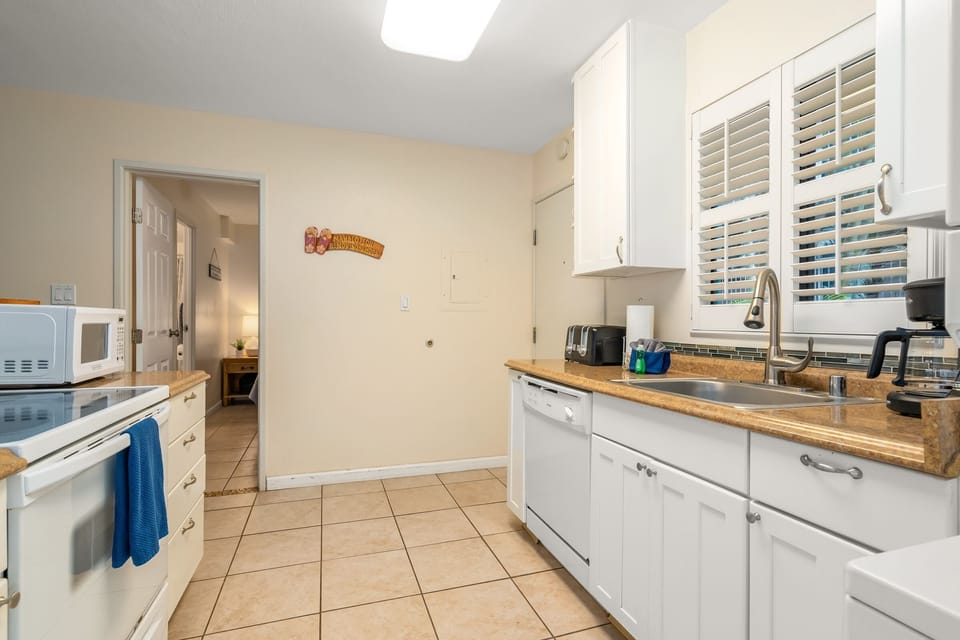 Fully stocked kitchen with pots, pans, plates, utensils, etc.
