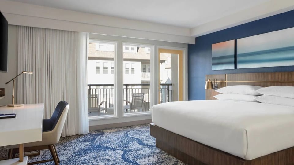 Unwind in a bright king room with balcony breezes.