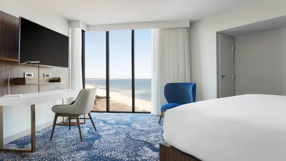 Wake up to sweeping ocean views from your serene bed.