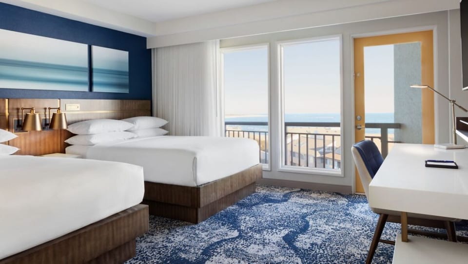 Settle into plush double beds with calming coastal views.